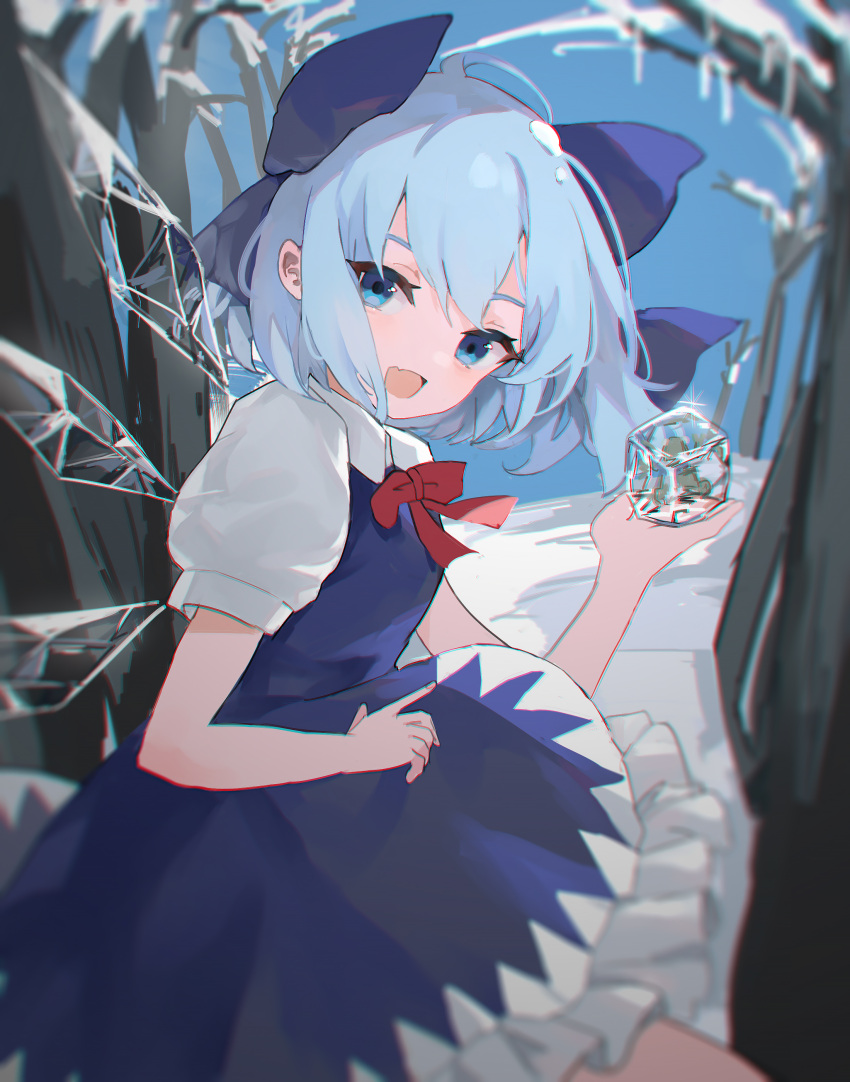 1girl :d absurdres bare_tree blue_bow blue_dress blue_eyes blue_hair blurry bow bowtie breasts chromatic_aberration cirno day depth_of_field dress fang frills frozen_frog hair_bow hand_up highres holding ice ice_wings kani_nyan looking_at_viewer looking_back open_mouth outdoors petite petticoat pinafore_dress red_bow red_bowtie short_hair skin_fang sleeveless sleeveless_dress small_breasts smile soft_focus solo touhou tree wings