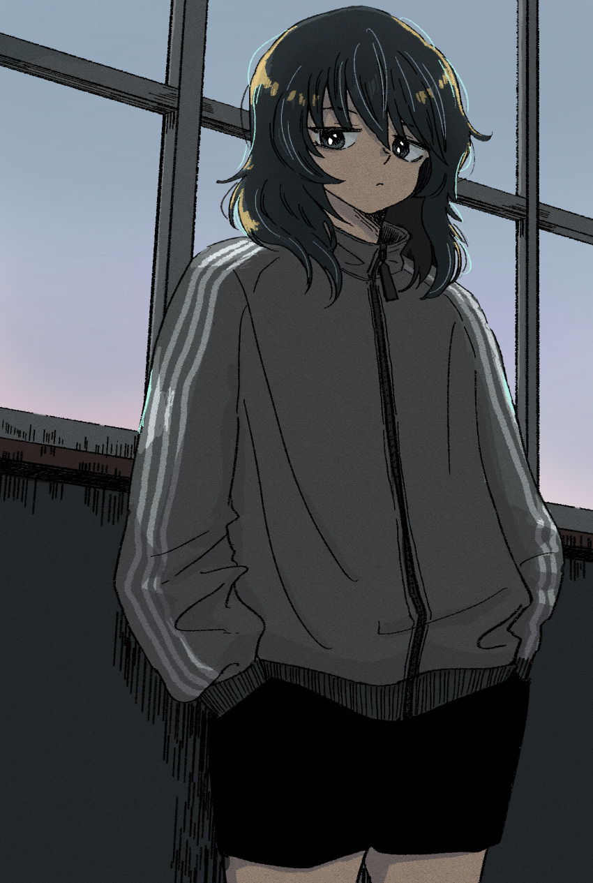 1girl amakusagoro andou_(girls_und_panzer) black_eyes black_hair black_shorts casual closed_mouth cowboy_shot dark dark-skinned_female dark_skin frown girls_und_panzer girls_und_panzer_saishuushou grey_jacket half-closed_eyes hands_in_pockets highres indoors jacket long_sleeves looking_at_viewer medium_hair messy_hair shorts solo standing track_jacket window