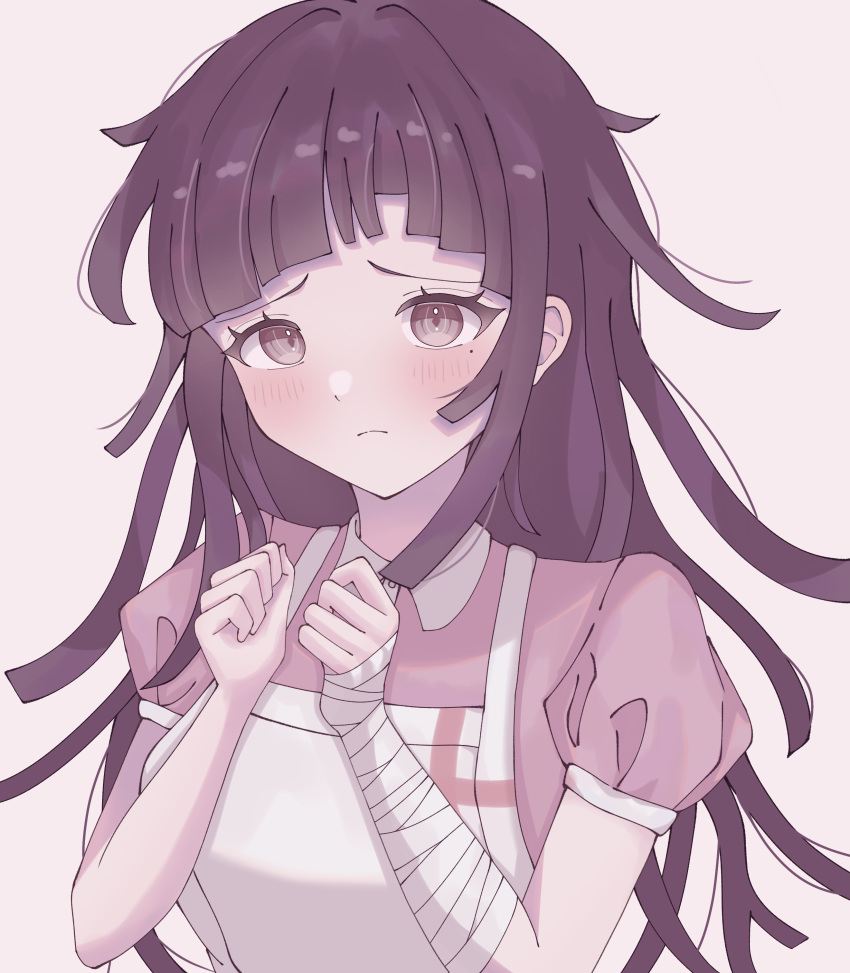 1girl absurdres apron bandaged_arm bandages black_hair blush breasts collared_shirt danganronpa_(series) danganronpa_2:_goodbye_despair hair_intakes hands_up highres large_breasts messy_hair mole mole_under_eye pink_shirt puffy_short_sleeves puffy_sleeves sad shirt short_sleeves simple_background solo tsumiki_mikan two-tone_shirt upper_body white_apron white_background yukino_(yukino00)