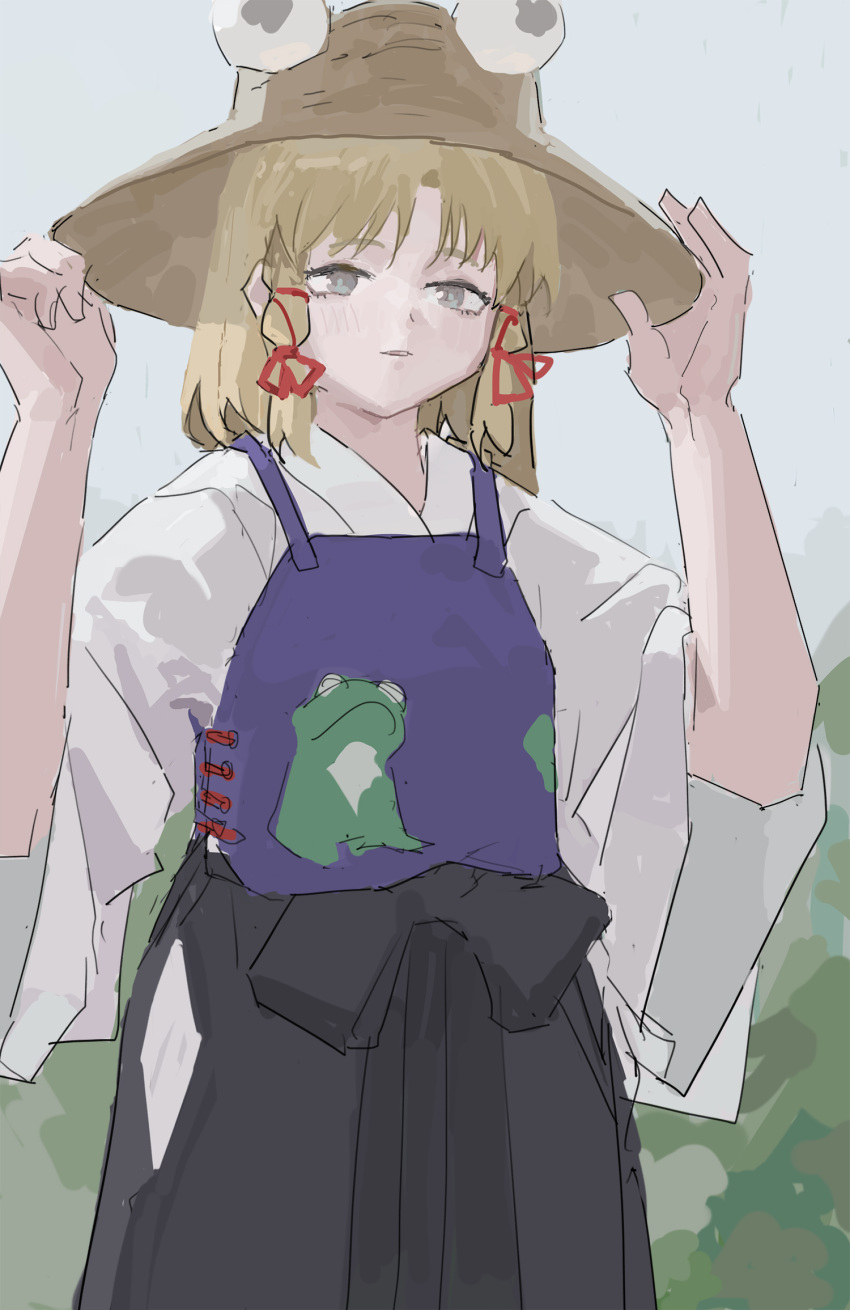 1girl adapted_costume animal_print blonde_hair cowboy_shot day frog_print grey_eyes hands_up hat highres light_smile medium_hair moriya_suwako outdoors overcast parted_lips purple_vest reisende1969 sky sleeves_past_elbows solo touhou vest wide_sleeves