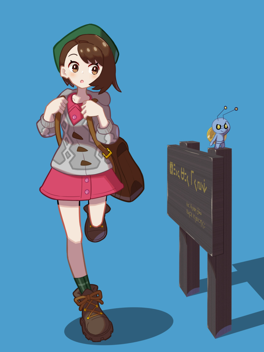 1girl :o backpack bag blue_background blush bob_cut boots brown_bag brown_eyes brown_footwear brown_hair buttons cable_knit cardigan collared_dress commentary_request dress gimmighoul gloria_(pokemon) green_headwear green_socks grey_cardigan hands_up highres holding_strap hooded_cardigan leg_up pink_dress plaid_socks pokemon pokemon_(creature) pokemon_(game) pokemon_swsh rubyhoenn short_hair sideways_glance sign socks