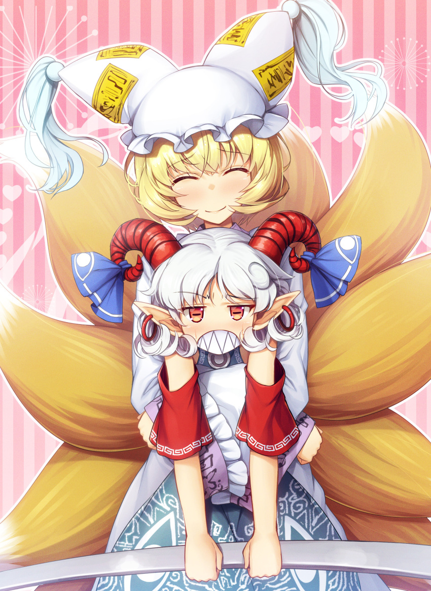 2girls absurdres animal_ears blonde_hair blue_dress blue_ribbon blush chima_q clenched_teeth curled_horns dress earrings fox_ears fox_tail grey_hair hat highres holding horn_ornament horn_ribbon horns jewelry long_sleeves mob_cap multiple_girls multiple_tails pointy_ears red_eyes red_horns red_sleeves ribbon sharp_teeth sheep_horns short_hair tail teeth touhou toutetsu_yuuma white_dress white_headwear wide_sleeves yakumo_ran