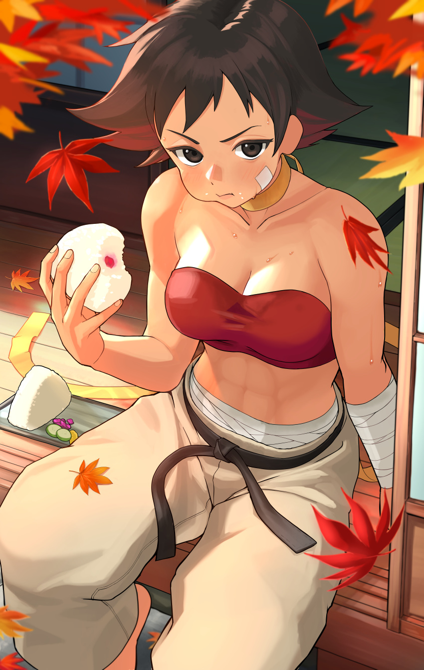 1girl absurdres bandaid bandaid_on_face belt black_belt breasts brown_eyes brown_hair choker cleavage dougi eating food highres holding holding_food kunimaki_(szxo7vln2nssgce) leaf looking_at_viewer makoto_(street_fighter) maple_leaf medium_breasts onigiri short_hair sitting solo strapless street_fighter toned tube_top yellow_choker