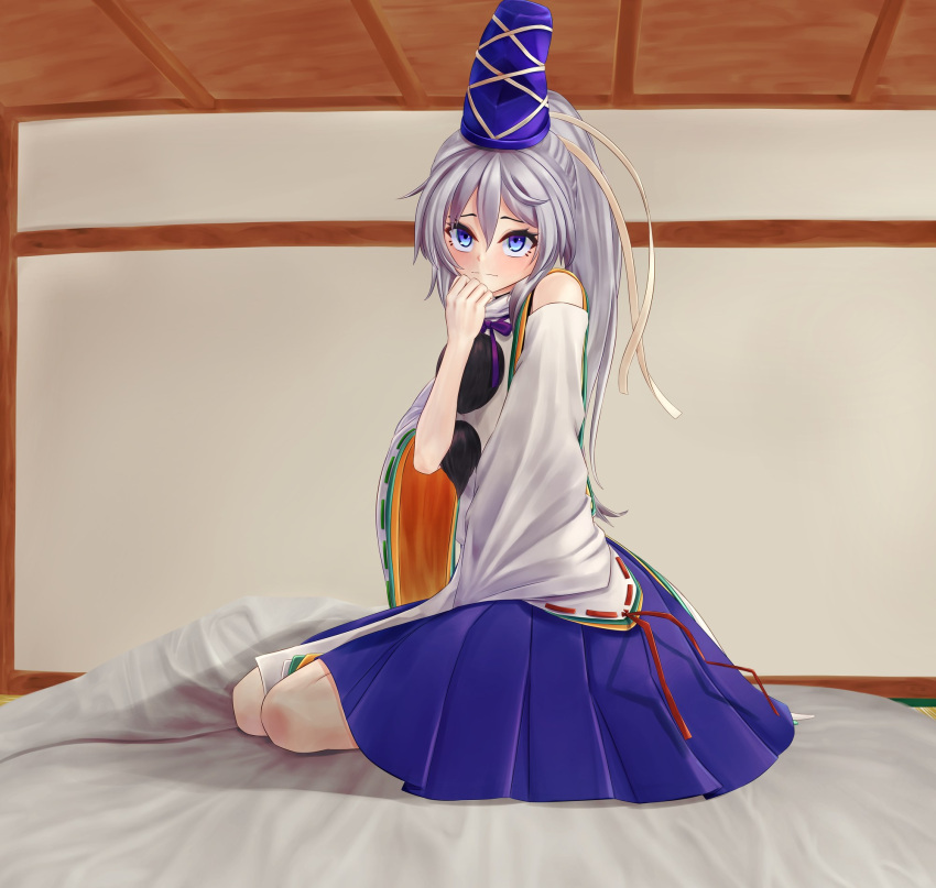 1girl blue_eyes blue_headwear blue_skirt closed_mouth commentary_request full_body grey_hair hat highres indoors long_hair looking_at_viewer mikotouca mononobe_no_futo pom_pom_(clothes) ponytail ribbon-trimmed_sleeves ribbon_trim sitting skirt smile solo tate_eboshi touhou variant_set