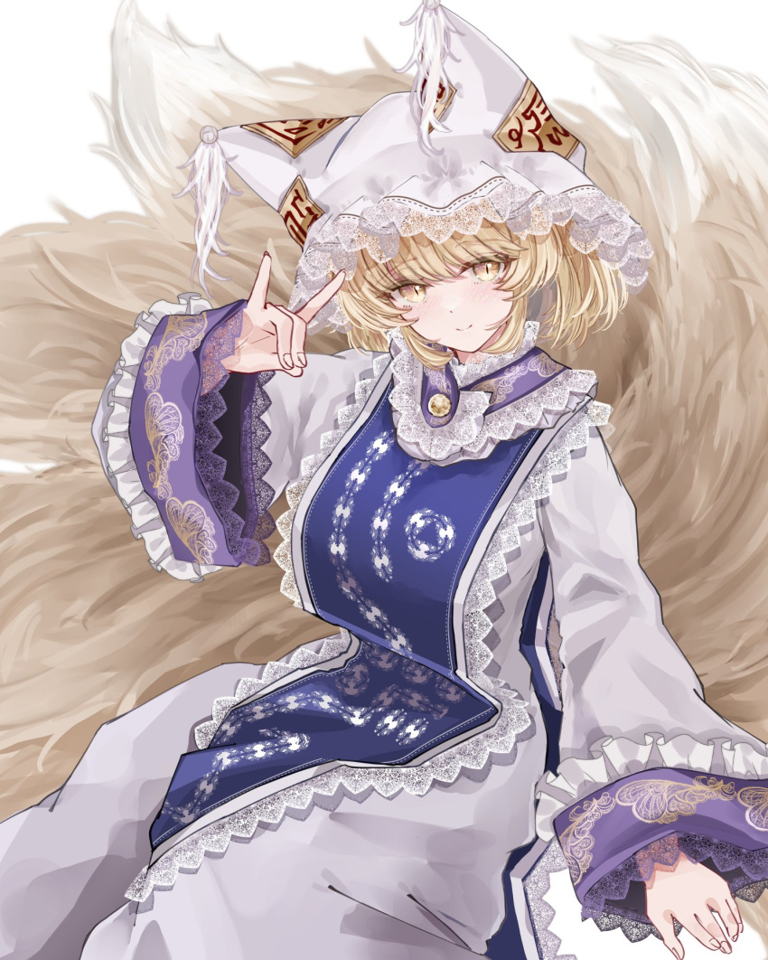 1girl blonde_hair blue_tabard closed_mouth commentary_request embellished_costume fingernails fox_shadow_puppet fox_tail hat highres looking_at_viewer mob_cap multiple_tails sarasadou_dan simple_background sitting slit_pupils smile solo tabard tail touhou white_background white_headwear yakumo_ran yellow_eyes