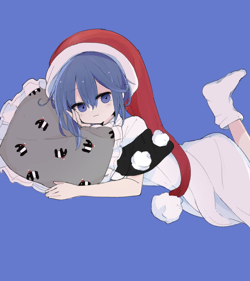 1girl 76gpo :3 black_capelet blue_background blue_eyes blue_hair capelet closed_mouth commentary_request doremy_sweet dress hat highres looking_at_viewer lying nightcap on_stomach pillow pom_pom_(clothes) red_headwear short_hair simple_background smile solo tapir tapir_print touhou white_dress white_footwear