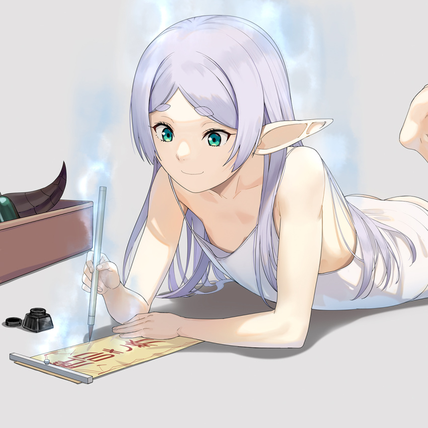 1girl a1 calligraphy_brush closed_mouth commentary_request dress elf flat_chest frieren green_eyes grey_background grey_hair highres holding holding_calligraphy_brush ink long_hair lying on_stomach paintbrush pointy_ears simple_background sleeveless sleeveless_dress smile solo sousou_no_frieren thick_eyebrows white_dress