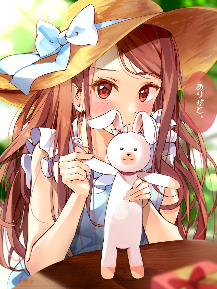 1girl absurdres bare_shoulders blue_dress blue_ribbon blurry blurry_background blush box breasts brown_eyes brown_hair day depth_of_field dress gift gift_box grass hair_over_shoulder hands_up hat hat_ribbon highres holding holding_stuffed_toy idolmaster idolmaster_(classic) idolmaster_million_live! idolmaster_million_live!_theater_days lens_flare long_hair looking_at_viewer minase_iori motion_lines nira_(vira) outdoors parted_lips ribbon round_table sleeveless sleeveless_dress small_breasts solo speech_bubble straw_hat stuffed_animal stuffed_rabbit stuffed_toy sunlight table translated tree upper_body usa-chan_(idolmaster) wooden_table