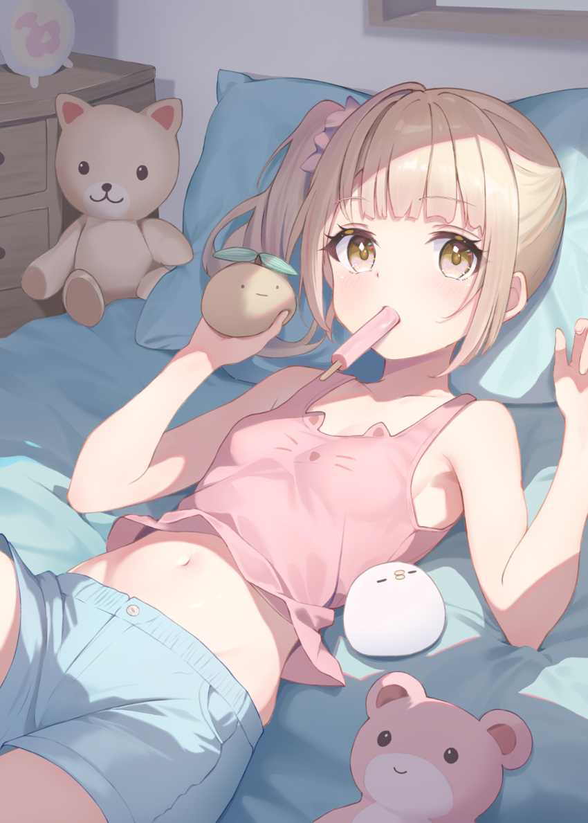 1girl armpits blonde_hair blue_shorts blunt_bangs breasts choppy_bangs commentary_request fanged_bangs food_in_mouth hair_ornament hair_scrunchie highres indoors looking_at_viewer medium_hair midriff mouth_hold navel on_bed original pink_scrunchie pink_tank_top popsicle_in_mouth scrunchie shorts side_ponytail small_breasts solo stuffed_animal stuffed_toy tank_top teddy_bear yellow_eyes yuna_rebun