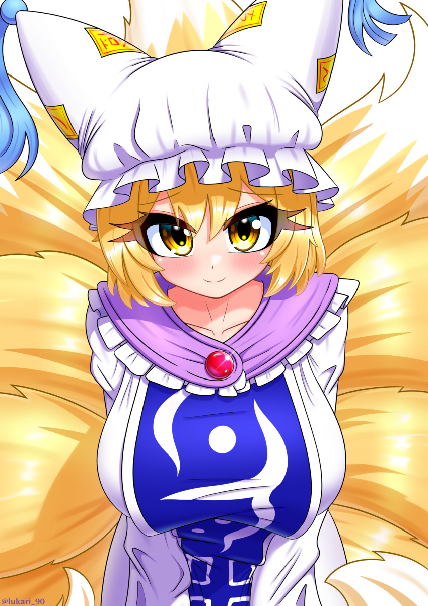 1girl animal_ears blonde_hair blue_tabard breasts brooch collarbone dress foreshortening fox_ears fox_tail frills glint hat highres huge_breasts jewelry leaning_forward looking_at_viewer lukari mob_cap multiple_tails short_hair simple_background smile solo tabard tail tassel touhou white_background white_dress yakumo_ran yellow_eyes