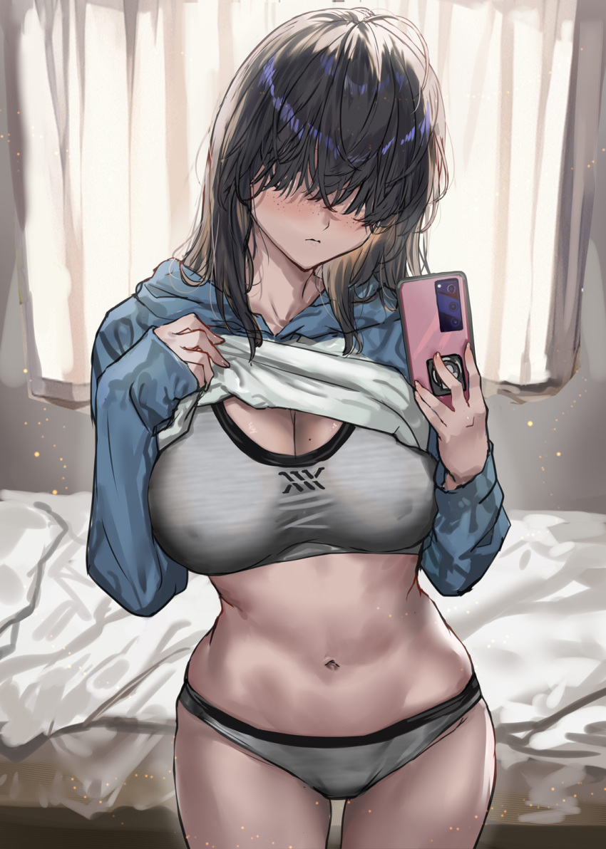 1girl black_hair blue_sweater blush breasts cellphone closed_mouth clothes_lift commentary_request cowboy_shot freckles grey_sports_bra hair_over_eyes highres holding holding_phone indoors large_breasts long_sleeves medium_hair mole mole_on_breast navel original phone ran'ou_(tamago_no_kimi) smartphone solo sports_bra stomach sweater sweater_lift