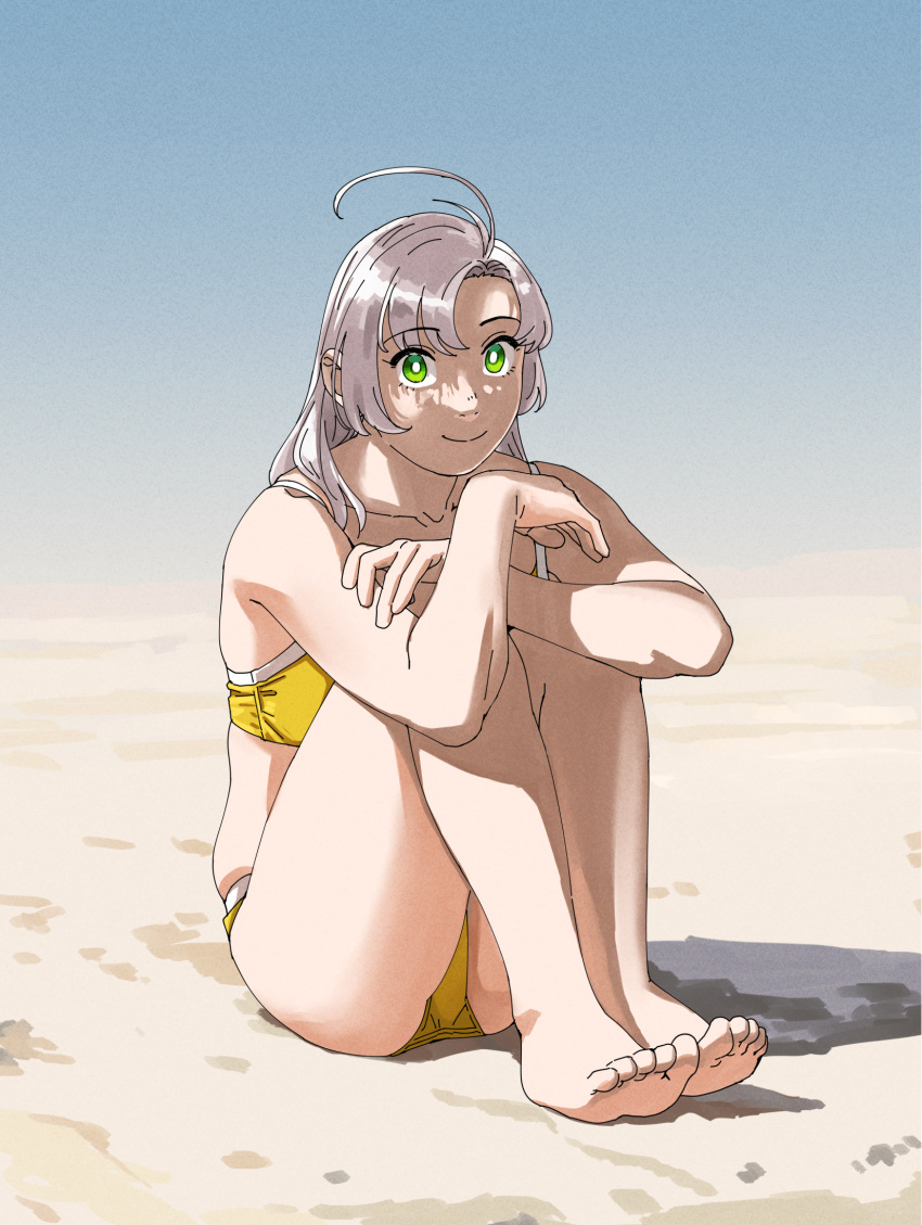 1girl antenna_hair arms_on_knees barefoot beach bikini collarbone dappled_sunlight feet green_eyes grey_hair highres kantai_collection kinugasa_(kancolle) kinugasa_kai_ni_(kancolle) knees_up legs looking_at_viewer medium_hair ojipon sitting smile solo sunlight swimsuit toes yellow_bikini