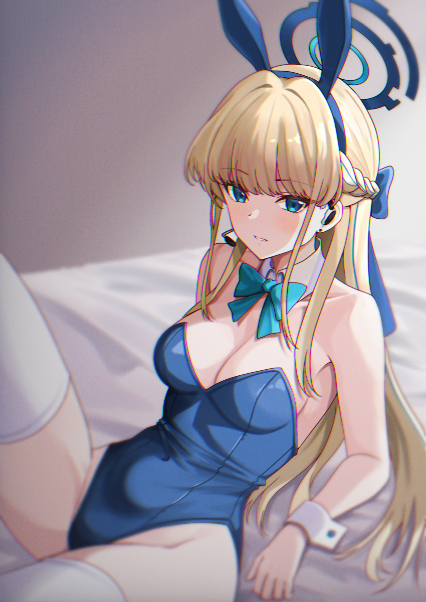 1girl absurdres animal_ears bed_sheet blonde_hair blue_archive blue_eyes blue_halo blue_leotard blush clenched_teeth detached_collar detached_sleeves fake_animal_ears halo highres leotard looking_at_viewer playboy_bunny rabbit_ears solo t.r teeth thighhighs toki_(blue_archive) toki_(bunny)_(blue_archive) white_thighhighs