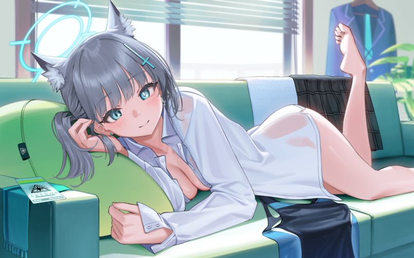 1girl animal_ear_fluff animal_ears bare_legs barefoot blinds blue_archive blush breasts cleavage couch earrings halo highres id_card indoors jewelry looking_at_viewer lying medium_breasts mismatched_pupils naked_shirt no_pants on_couch on_stomach see-through shiroko_(blue_archive) shirt side_ponytail skirt skirt_removed smile soles solo stud_earrings swimsuit swimsuit_removed toes wolf_ears yasawa_kichi