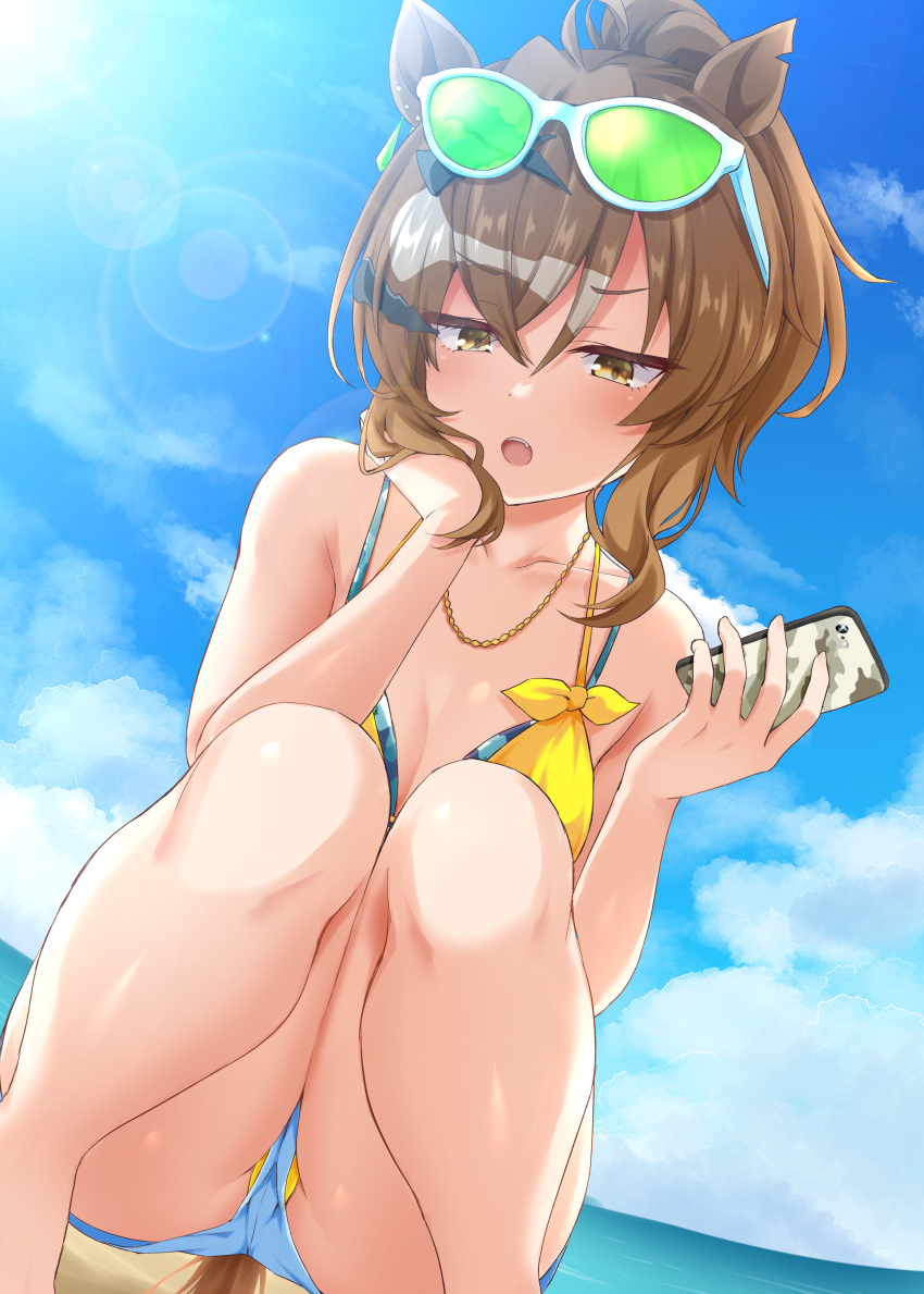 1girl absurdres animal_ears bare_shoulders beach bikini blue_sky blush breasts brown_hair cellphone cleavage cloud cloudy_sky commentary_request denim earrings eyewear_on_head hair_between_eyes hair_ornament head_rest highres holding holding_phone horse_ears horse_girl horse_tail jewelry jungle_pocket_(tobuze_hot_summer!)_(umamusume) jungle_pocket_(umamusume) necklace notched_ear ocean open_mouth outdoors phone ponytail ryochapu sand single_earring sky small_breasts smartphone solo squatting summer's_sunlight_fades_to_blue_(umamusume) sunglasses swimsuit tail umamusume water x_hair_ornament yellow_bikini yellow_eyes