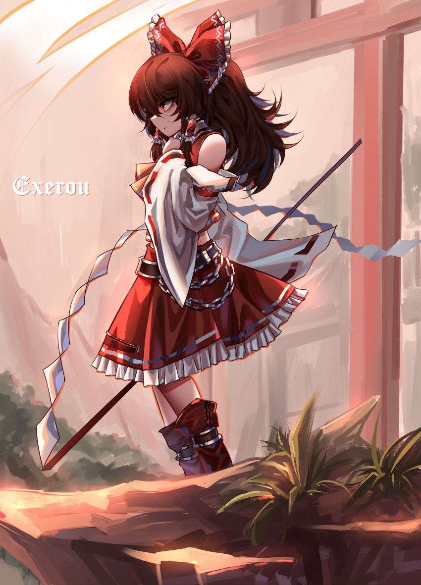 1girl absurdres bare_shoulders boots bow brown_hair chain closed_mouth commentary_request detached_sleeves from_side full_body gohei hair_bow hair_tubes hakurei_reimu highres holding long_hair outdoors red_bow red_eyes red_skirt ribbon-trimmed_sleeves ribbon_trim sidelocks skirt solo top-exerou torii touhou
