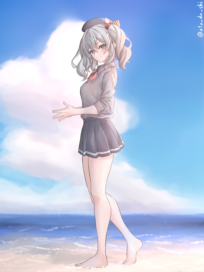 1girl absurdres atodashi barefoot beach beret black_headwear black_skirt blue_eyes blue_sky breasts cloud collared_shirt day from_side full_body grey_hair grey_shirt hat highres kantai_collection kashima_(kancolle) large_breasts looking_at_viewer miniskirt neckerchief ocean outdoors pleated_skirt red_neckerchief shirt sidelocks skirt sky smile solo standing twintails wavy_hair