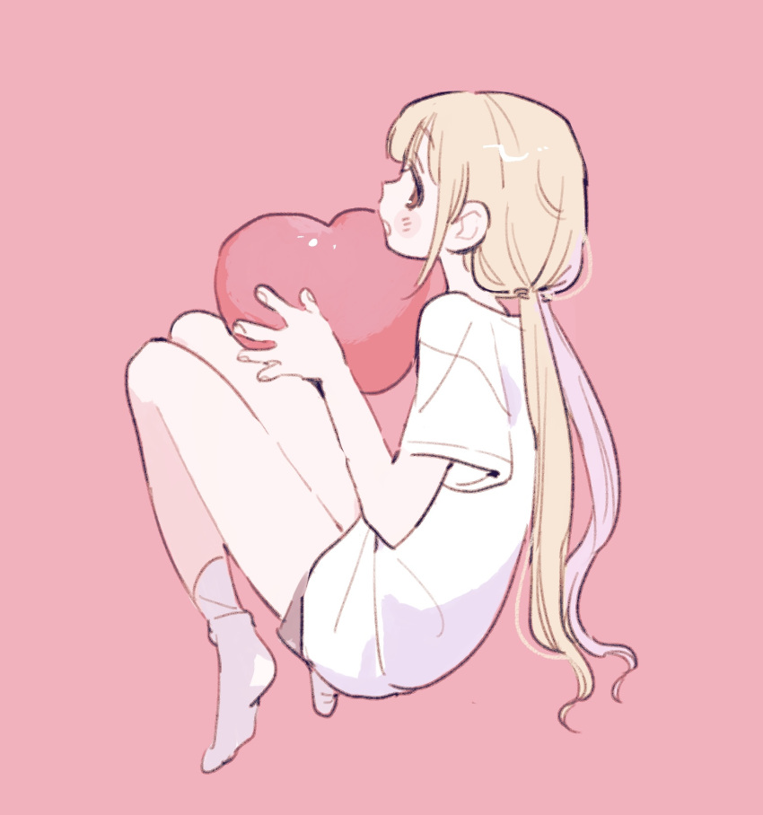 1girl blonde_hair blush brown_eyes from_side full_body futaba_anzu gohanysu heart highres holding holding_heart idolmaster idolmaster_cinderella_girls knees_up long_hair low_twintails no_shoes pink_background profile shirt simple_background smile socks solo t-shirt twintails white_shirt white_socks