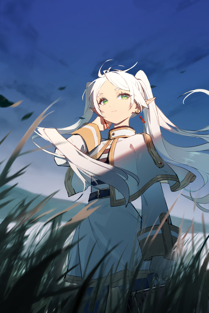 1girl absurdres belt bilibilida blue_sky capelet closed_mouth dress earrings elf frieren from_below grass green_eyes hair_lift highres jewelry long_hair outdoors pointy_ears sky solo sousou_no_frieren twintails white_capelet white_dress white_hair