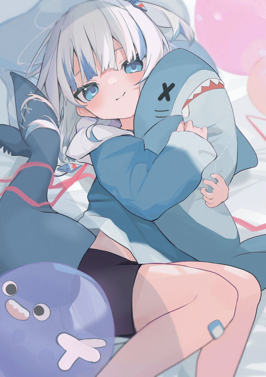 1girl absurdres alternate_hairstyle animal_hood bandaid bandaid_on_knee bandaid_on_leg bed_sheet bike_shorts biting black_shorts bloop_(gawr_gura) blue_eyes blue_hair blue_hoodie blurry blush commentary cropped_legs depth_of_field fins fish_tail gawr_gura gawr_gura_(1st_costume) hair_ornament highres hololive hololive_english hood hood_down hoodie light_blue_hair long_sleeves looking_at_viewer lying medium_hair midriff_peek multicolored_hair object_hug on_side one_side_up oreoreoreo shark_girl shark_hair_ornament shark_hood shark_tail shorts sleeves_past_wrists solo split_mouth streaked_hair stuffed_animal stuffed_shark stuffed_toy symbol-only_commentary tail virtual_youtuber x