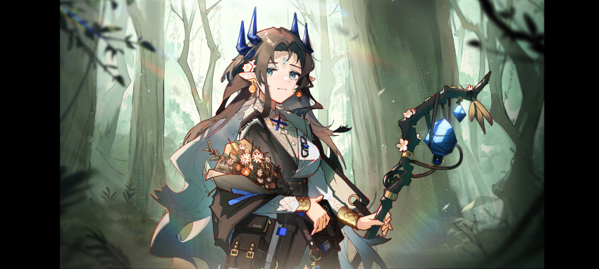 1girl absurdres arknights belt black_bag black_belt black_dress blue_ribbon blurry bracelet brown_hair demon_horns dress earrings flower forehead_jewel forest full_body grey_eyes hair_flower hair_ornament highres holding holding_staff holding_weapon horns huajiaohaibao jewelry leaf long_hair long_sleeves mole mole_under_mouth nature pointy_ears rainbow_background ribbon simple_background staff standing sunlight tree valarqvin_(arknights) weapon white_flower