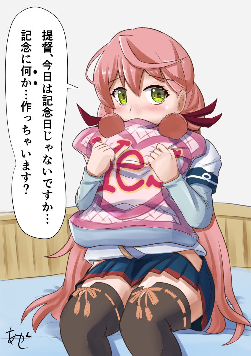 1girl akashi_(kancolle) akashieru bed blue_skirt blunt_tresses commentary_request cowboy_shot green_eyes hair_ribbon highres hip_vent kantai_collection layered_sleeves long_hair long_sleeves object_hug pillow pillow_hug pink_hair pleated_skirt ribbon short_over_long_sleeves short_sleeves sitting skirt solo thighhighs tress_ribbon yes-no_pillow