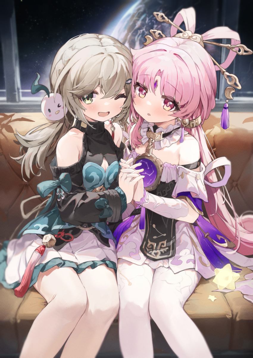 2girls :o ;d bare_shoulders blonde_hair clothing_cutout commentary coria couch dress feet_out_of_frame forehead_jewel frilled_skirt frills fu_xuan_(honkai:_star_rail) green_dress green_eyes hair_ornament hair_rings hair_stick hairclip highres holding_hands honkai:_star_rail honkai_(series) interlocked_fingers layered_clothes long_hair looking_at_viewer low_twintails multiple_girls on_couch one_eye_closed open_mouth pantyhose parted_bangs pink_eyes pink_hair planet qingque_(honkai:_star_rail) shoulder_cutout sitting skirt smile space star_(symbol) symbol-only_commentary tassel twintails white_pantyhose white_skirt window