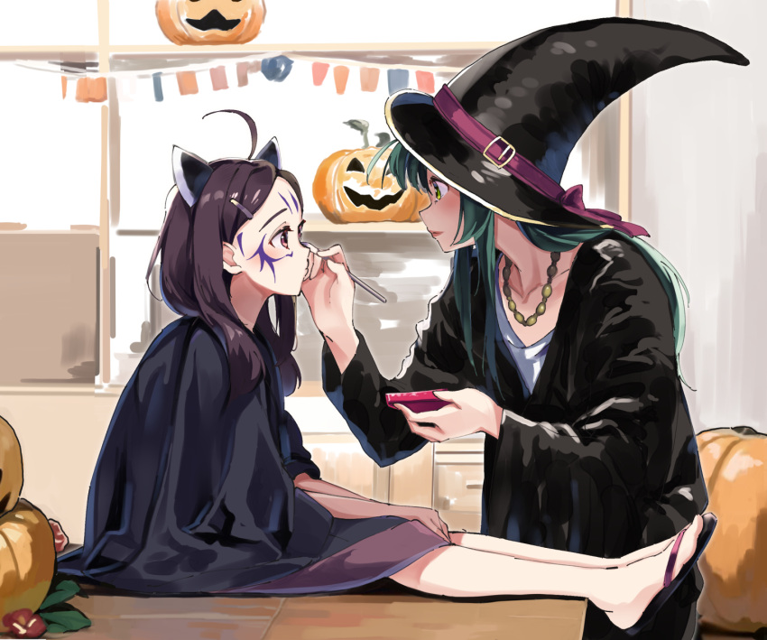 2girls ahoge black_footwear black_headwear black_robe brown_hair brown_skirt closed_mouth collarbone commentary_request drawing_on_another's_face eye_contact facepaint from_side green_eyes green_hair hair_ornament hairclip halloween hat headgear highres holding jack-o'-lantern lamb_(hitsujiniku) long_hair long_sleeves looking_at_another multiple_girls on_table painting_(action) parted_bangs profile red_lips robe shirt sitting skirt string_of_flags table touhoku_kiritan touhoku_zunko voiceroid white_shirt wide_sleeves witch_hat zouri