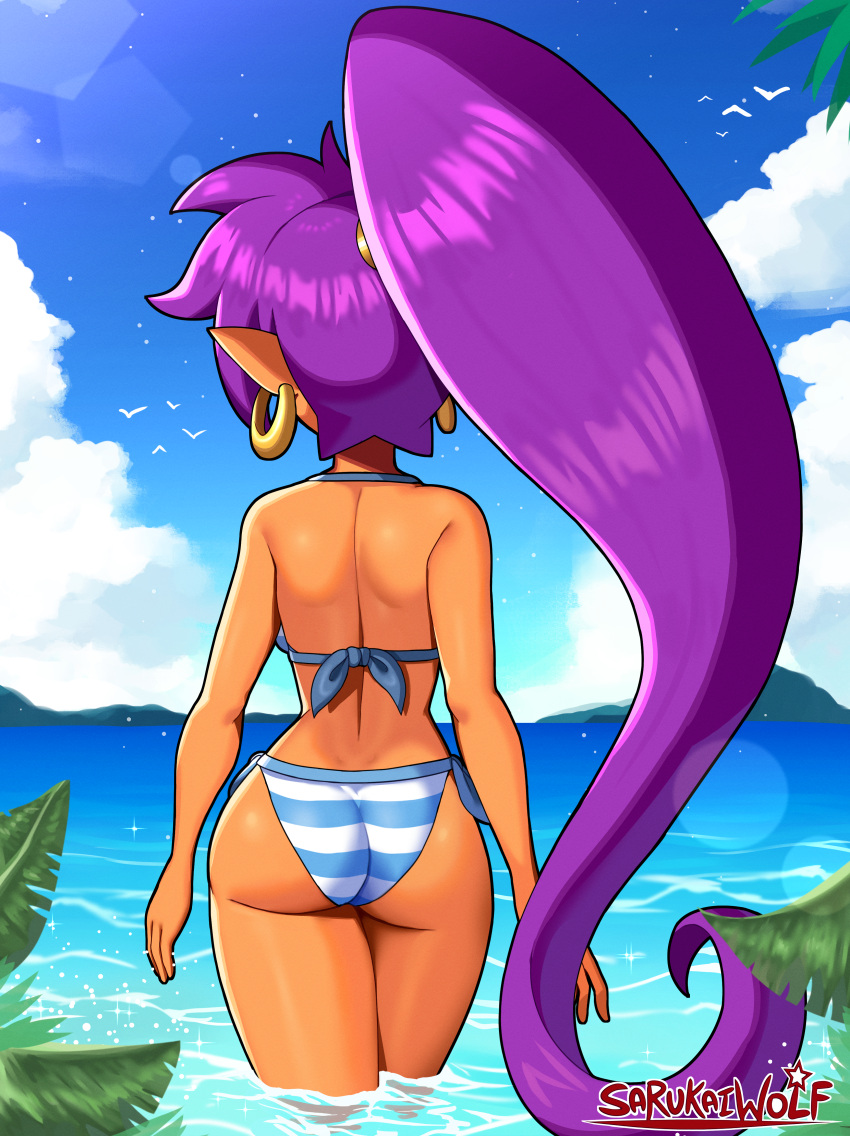 1girl absurdres arms_at_sides artist_name ass back bikini blue_sky breasts cloud cowboy_shot dark-skinned_female dark_skin day dimples_of_venus earrings english_commentary facing_away from_behind highres island jewelry long_hair median_furrow medium_breasts ocean outdoors palm_tree pointy_ears ponytail purple_hair sarukaiwolf shantae shantae_(series) shoulder_blades side-tie_bikini_bottom sky solo striped striped_bikini swimsuit tree very_long_hair wading water