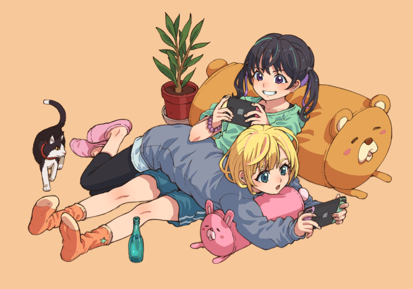 2girls animal ankle_socks black_hair blonde_hair blue_eyes bottle brown_eyes cat colored_inner_hair grin highres leggings_under_shorts lying_on_person multicolored_hair multiple_girls nintendo_switch no_shoes original pillow plant playing_games potted_plant purple_hair reclining shorts simple_background sitting smile socks tanuki_koubou twintails two-tone_hair