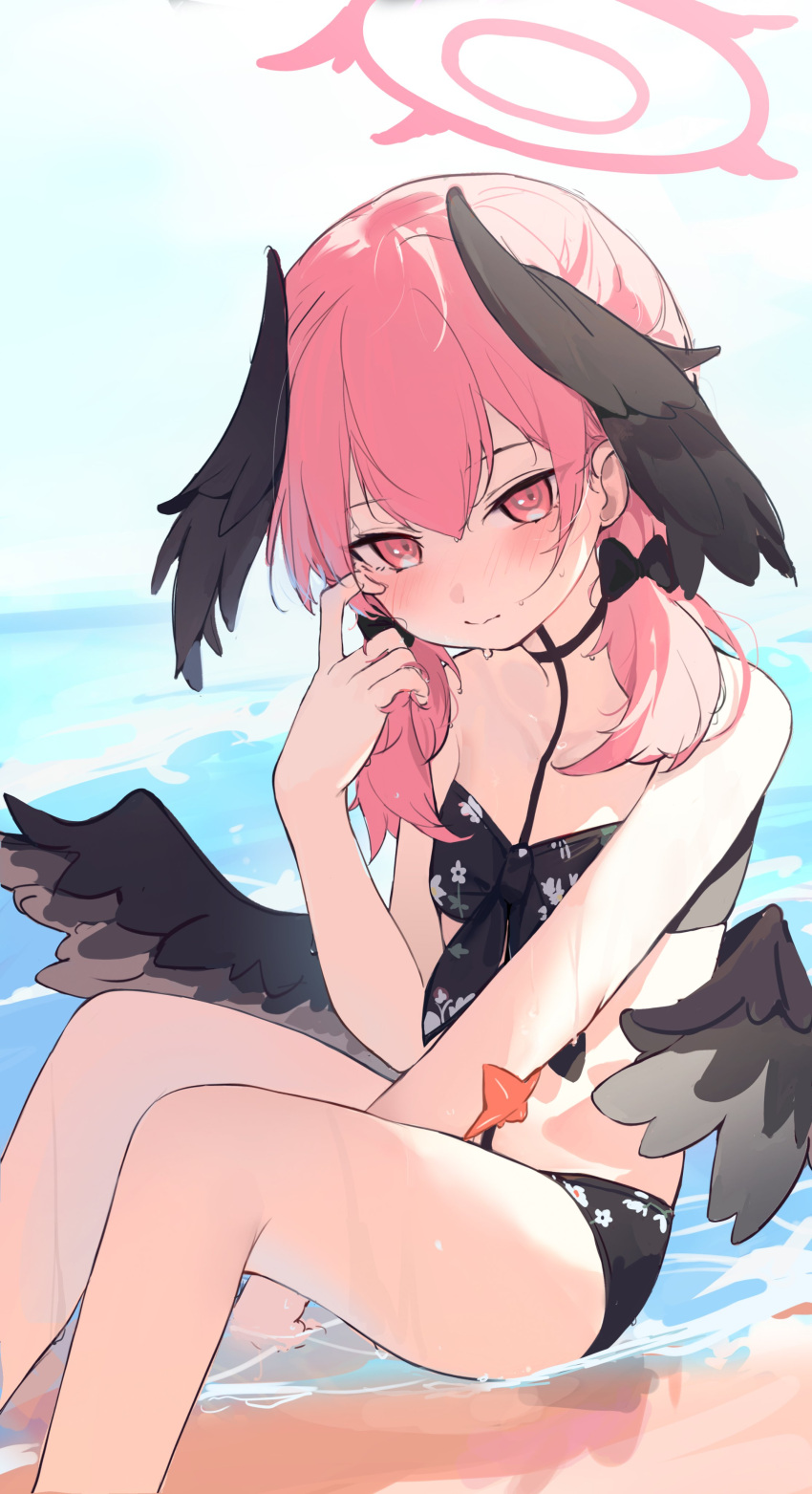 1girl absurdres beach bikini black_bikini black_bow black_wings blue_archive blush bow closed_mouth day feathered_wings flat_chest floral_print hair_bow halo head_wings highres koharu_(blue_archive) koharu_(swimsuit)_(blue_archive) looking_at_viewer mini_wings outdoors pink_hair shenqi_de_(9) sitting solo starfish swimsuit twintails water wet wings