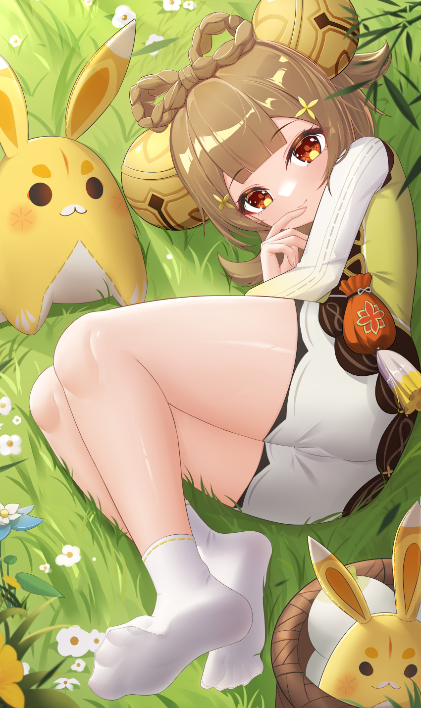 1girl absurdres ass bare_legs bell blunt_bangs blush bow-shaped_hair braid brown_hair chinese_commentary closed_mouth commentary_request dress feet finger_to_mouth flower foot_up genshin_impact green_dress hair_bell hair_ornament highres in_basket jingle_bell jndfh knees_up legs looking_at_viewer lying medium_hair nail_polish nature no_shoes on_grass on_side outdoors paid_reward_available red_eyes sack short_dress short_shorts shorts smile socks soles spread_toes stuffed_animal stuffed_rabbit stuffed_toy tassel toenail_polish toenails toes white_shorts white_sleeves white_socks yaoyao_(genshin_impact) yuegui_(genshin_impact)