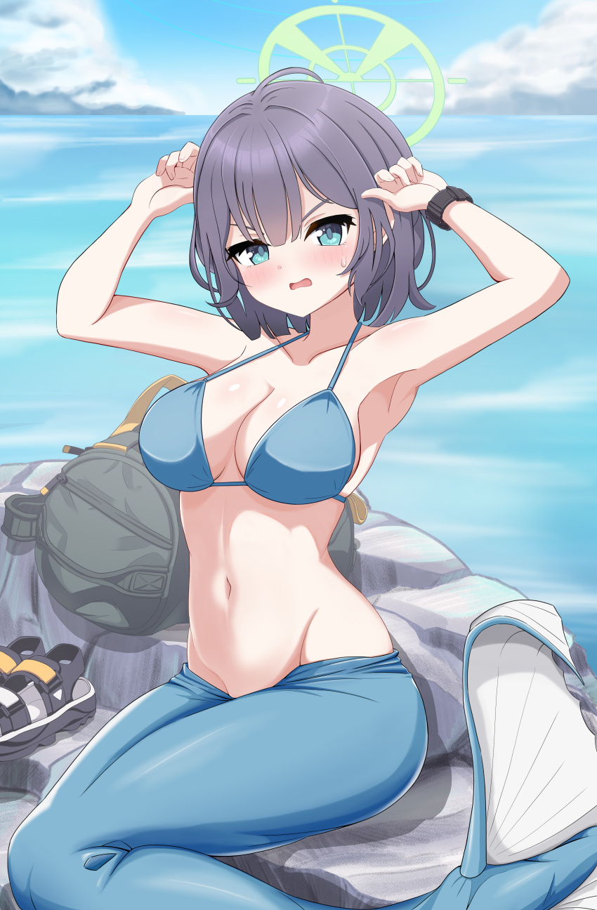 1girl absurdres arms_up backpack bag bikini blue_archive blue_bikini blue_eyes blue_hair blush breasts commentary_request dark_blue_hair day halo highres looking_at_viewer medium_breasts medium_hair mermaid_costume monofin navel no_headwear ocean official_alternate_costume outdoors parted_lips poorunii rock saki_(blue_archive) saki_(swimsuit)_(blue_archive) sitting solo stomach swimsuit variant_set watch wristwatch