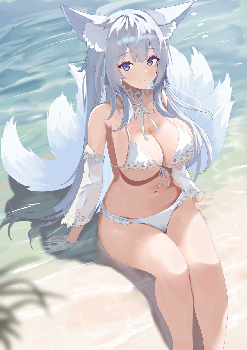 1girl animal_ear_fluff animal_ears arm_rest azur_lane beach bikini blue_eyes breasts cleavage closed_mouth detached_sleeves duosix_setsu0408 fox_ears fox_tail highres kitsune large_breasts long_hair looking_at_viewer mole mole_under_eye navel official_alternate_costume outdoors sand see-through see-through_sleeves shinano_(azur_lane) sitting smile solo stomach swimsuit tail water white_bikini white_hair white_tail