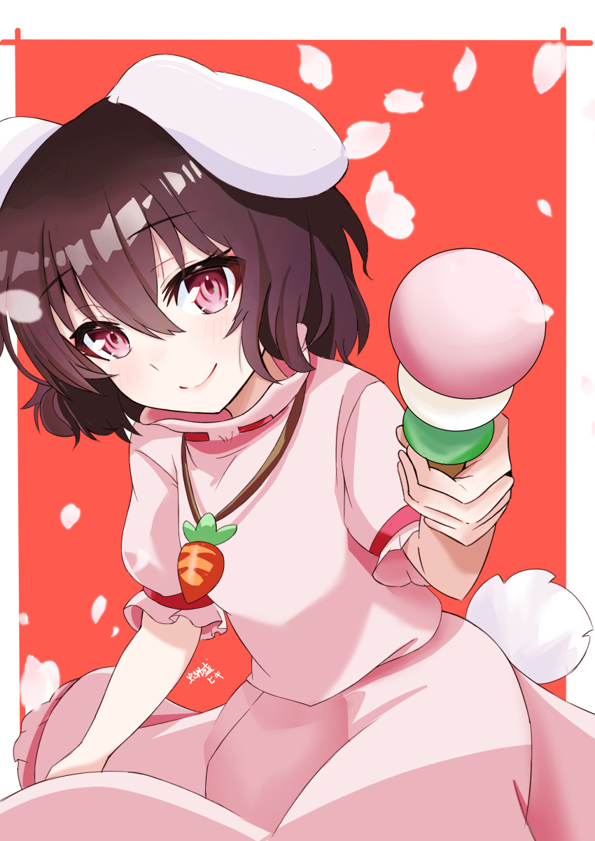 1girl absurdres animal_ears breasts brown_hair carrot_necklace closed_mouth commentary dango dress floppy_ears food foreshortening hair_between_eyes highres holding holding_food inaba_tewi incoming_food jewelry leaning_forward light_blush looking_at_viewer necklace otsu_oki_yuhi petals pink_dress pink_eyes puffy_short_sleeves puffy_sleeves rabbit_ears rabbit_tail reaching reaching_towards_viewer red_background short_hair short_sleeves signature simple_background small_breasts smile solo tail touhou wagashi