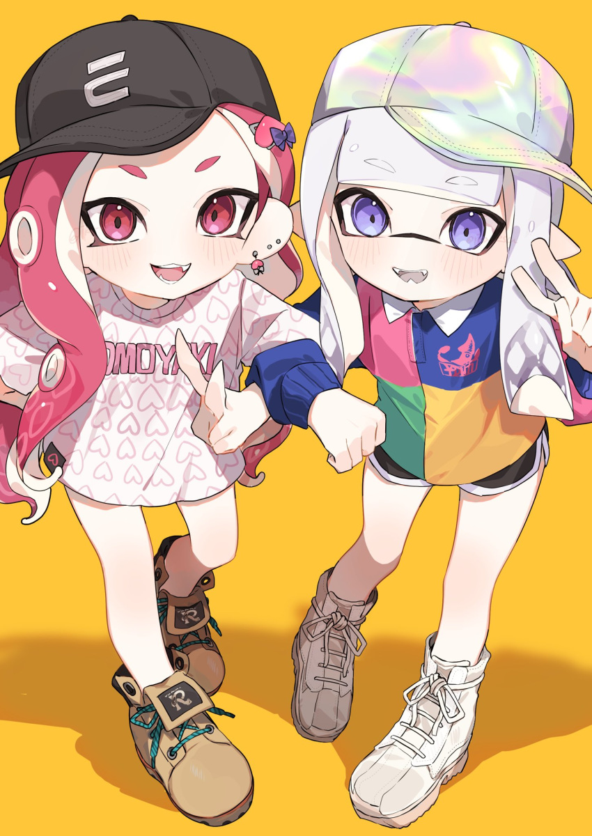 2girls :d asymmetrical_hair baseball_cap black_headwear black_shorts blue_shirt blunt_bangs blush boots bow brown_footwear clothes_writing collared_shirt colored_tongue commentary earrings fangs forehead green_shirt hair_bow hand_up hat heart heart_earrings heart_print highres ika_esu inkling inkling_girl jewelry light_purple_hair locked_arms long_hair long_sleeves looking_at_viewer multicolored_clothes multicolored_headwear multicolored_shirt multiple_earrings multiple_girls octoling octoling_girl open_mouth parted_bangs pink_eyes pink_hair pointy_ears polo_shirt purple_bow purple_eyes red_shirt shadow shirt short_eyebrows short_shorts shorts sidelocks simple_background smile splatoon_(series) standing stud_earrings suction_cups symbol-only_commentary teeth tentacle_hair tilted_headwear v v-shaped_eyebrows white_footwear white_shirt yellow_background yellow_shirt