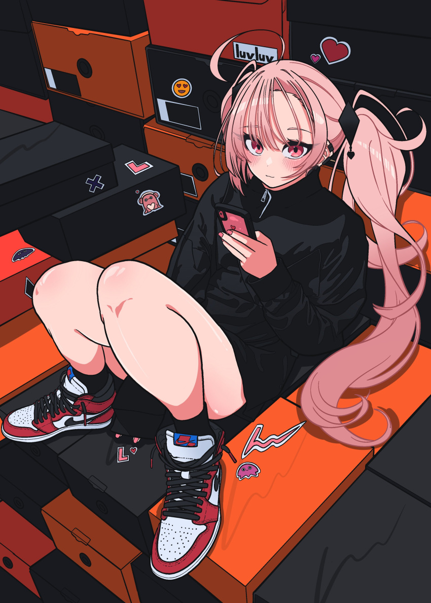 1girl absurdres air_jordan black_jacket blunt_bangs blush ear_piercing heart highres holding holding_phone jacket long_sleeves looking_at_viewer luvluvvox lying nike on_back original phone piercing pink_eyes pink_nails shoe_box sticker twintails