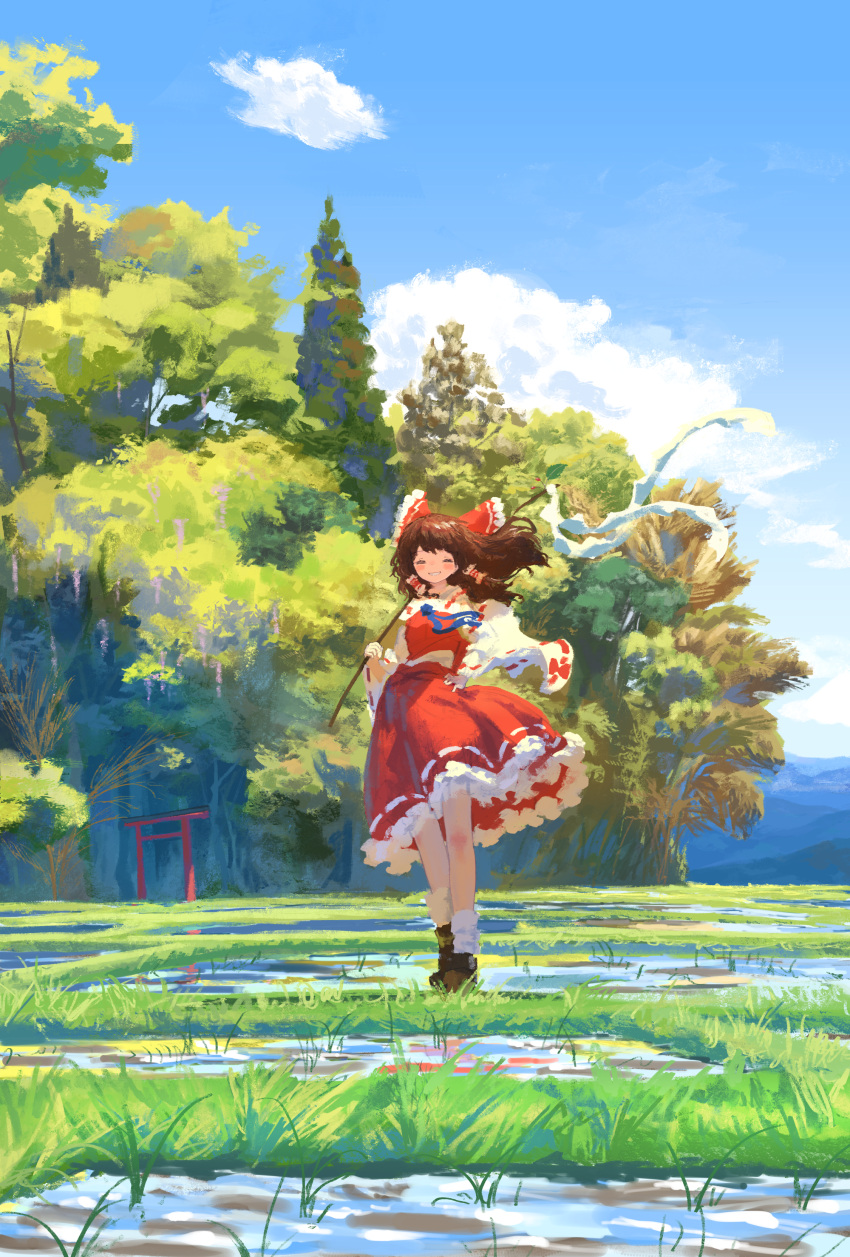 1girl absurdres bare_shoulders black_footwear blush bow brown_hair closed_eyes cloud day detached_sleeves frilled_skirt frills full_body gohei grin hair_bow hair_tubes hakurei_reimu hand_on_own_hip highres holding holding_gohei japanese_clothes kajatony long_hair nontraditional_miko outdoors red_bow red_skirt ribbon-trimmed_sleeves ribbon_trim shoes sidelocks skirt sky smile socks solo torii touhou tree white_sleeves white_socks wide_sleeves