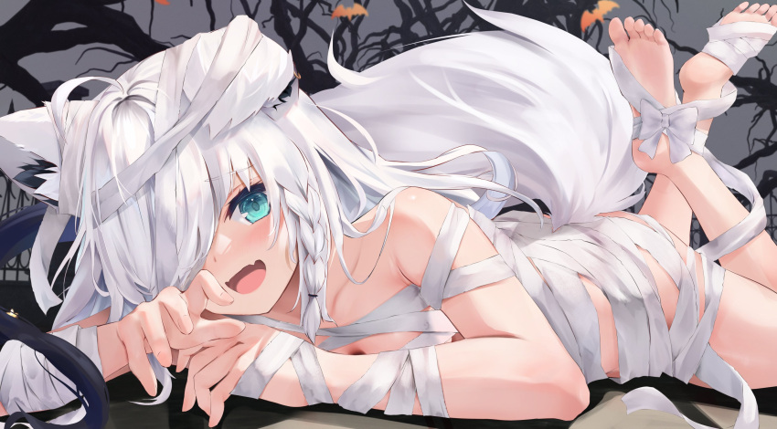 1girl ahoge animal_ears bandaged_arm bandaged_foot bandages bare_tree blue_eyes blush commentary_request fang feet_up fox_ears fox_tail grey_background hair_over_one_eye halloween highres hololive long_bangs long_hair looking_at_viewer lying naked_bandage on_stomach one_eye_covered open_mouth shirakami_fubuki skin_fang smile soles solo tail the_pose toes tree uechin_ewokaku virtual_youtuber white_hair