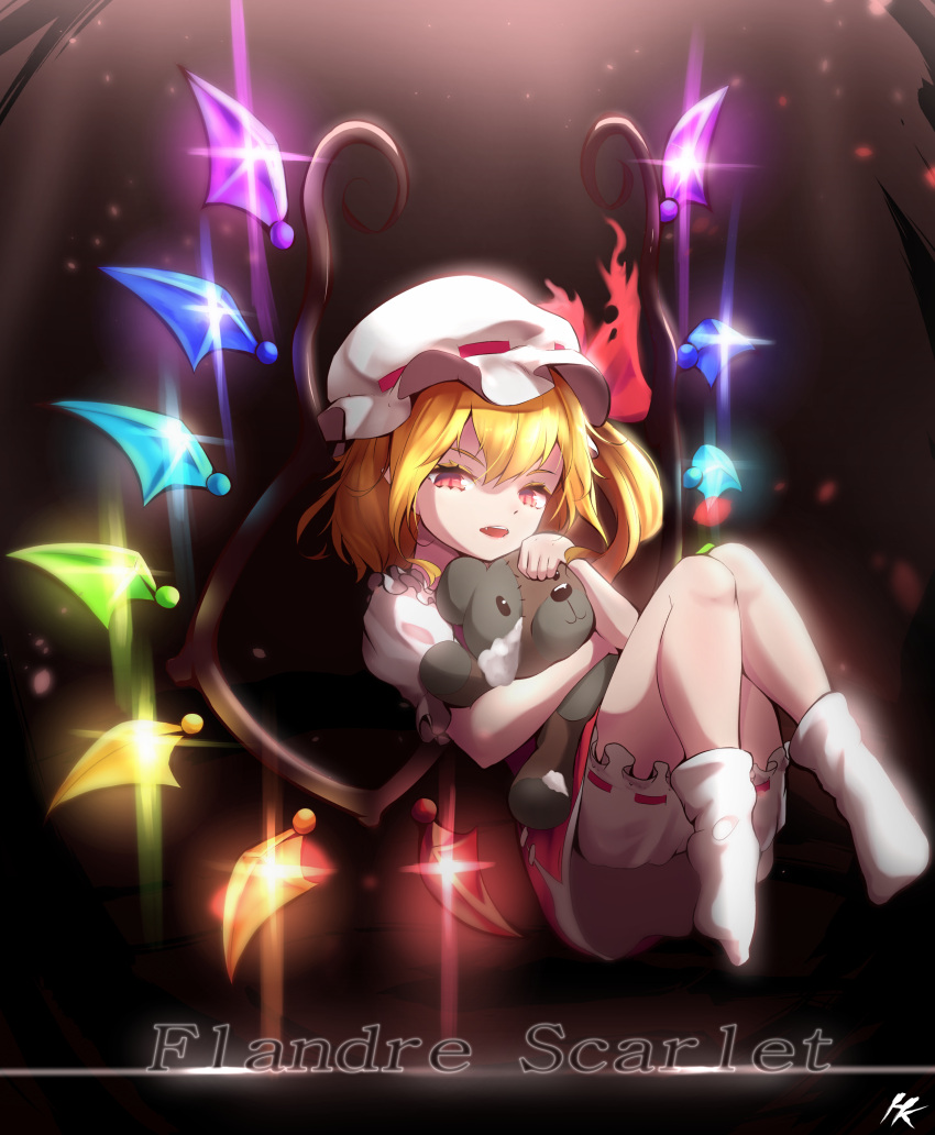 1girl absurdres blonde_hair bloomers character_name dark_background flandre_scarlet frilled_sleeves frills full_body glowing glowing_wings ha_kang hair_between_eyes hat highres holding holding_stuffed_toy looking_at_viewer medium_hair mob_cap multicolored_wings no_shoes one_side_up open_mouth puffy_short_sleeves puffy_sleeves rainbow_order red_eyes red_skirt red_vest ribbon-trimmed_bloomers shirt short_sleeves skirt socks solo stuffed_animal stuffed_toy teddy_bear teeth touhou upper_teeth_only vest white_bloomers white_headwear white_shirt white_socks wings