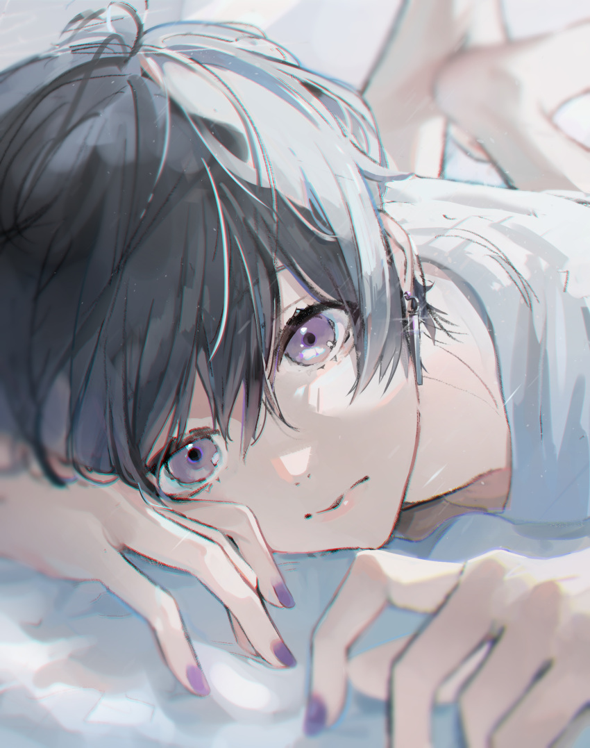 1boy barefoot bishounen black_hair blurry closed_mouth dangle_earrings depth_of_field earrings expressionless highres jewelry looking_at_viewer lying male_focus nail_polish on_stomach original purple_eyes purple_nails sai_gumi shirt short_hair sparkle the_pose white_shirt