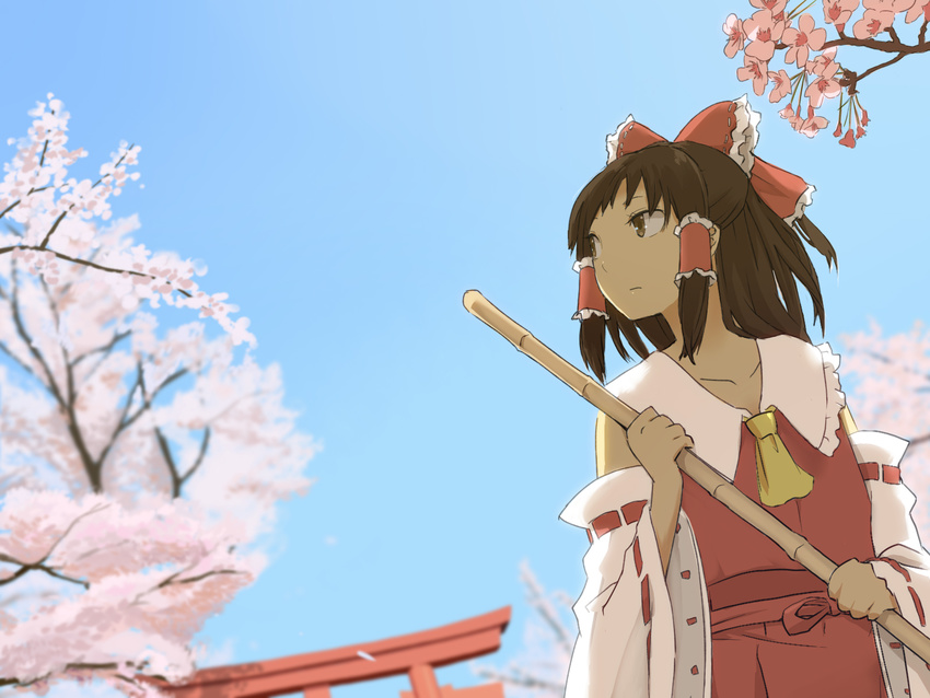 ascot bad_id bad_pixiv_id bamboo_broom blue_sky bow broom brown_eyes brown_hair cherry_blossoms collarbone day detached_sleeves hair_bow hair_tubes hakurei_reimu highres long_hair potionu skirt sky solo torii touhou vest