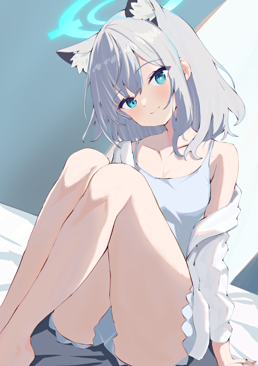 1girl animal_ear_fluff animal_ears aqua_eyes arm_support bare_legs barefoot bed_sheet blue_archive blush breasts camisole collarbone extra_ears grey_camisole grey_hair halo head_tilt highres knees_up legs_together looking_at_viewer mismatched_pupils natsuki_(natsu_1936) shiroko_(blue_archive) shirt single_bare_shoulder sitting small_breasts smile solo white_shirt wolf_ears