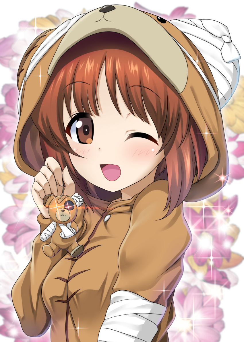 1girl ;d absurdres animal_costume bandaid bangs bear_costume blurry blurry_background boko_(girls_und_panzer) brown_eyes brown_hair cast commentary diffraction_spikes excel_(shena) eyebrows_visible_through_hair floral_background girls_und_panzer glowing glowing_eyes highres holding light_blue_hair long_sleeves looking_at_viewer nishizumi_miho one_eye_closed open_mouth pajamas short_hair sling smile solo sparkle stuffed_animal stuffed_toy teddy_bear upper_body