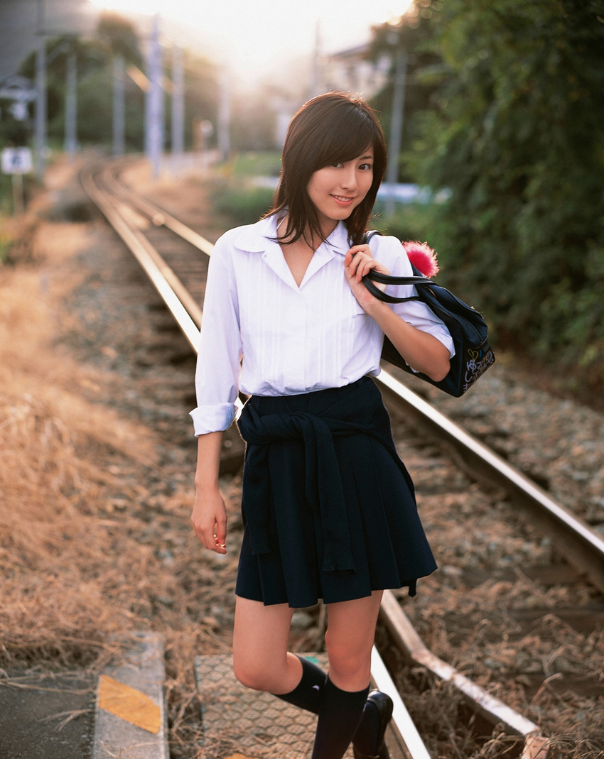 1girl asian brown_hair cosplay highres knee_socks kneehighs long_hair looking_at_viewer miniskirt photo pleated_skirt railroad_crossing railroad_tracks school_bag school_uniform serafuku skirt socks solo standing sugimoto_yumi train_tracks