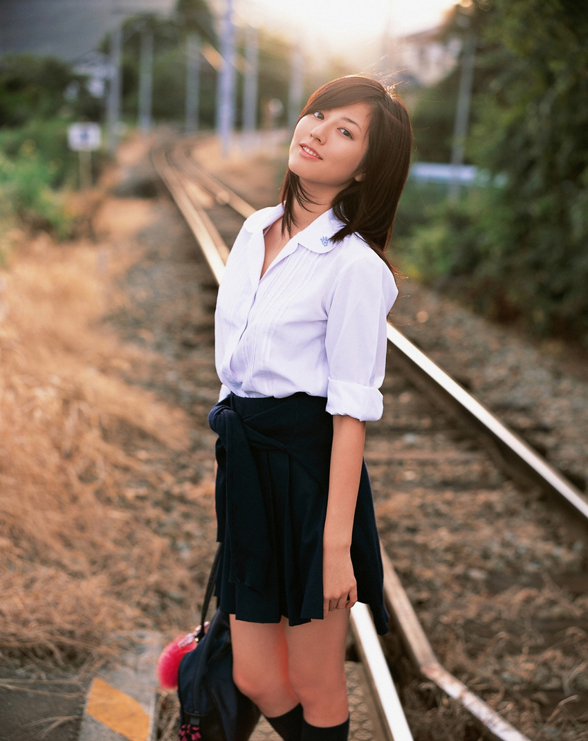 1girl asian brown_hair cosplay highres knee_socks kneehighs long_hair looking_at_viewer miniskirt photo pleated_skirt railroad_crossing railroad_tracks school_bag school_uniform serafuku skirt socks solo standing sugimoto_yumi train_tracks