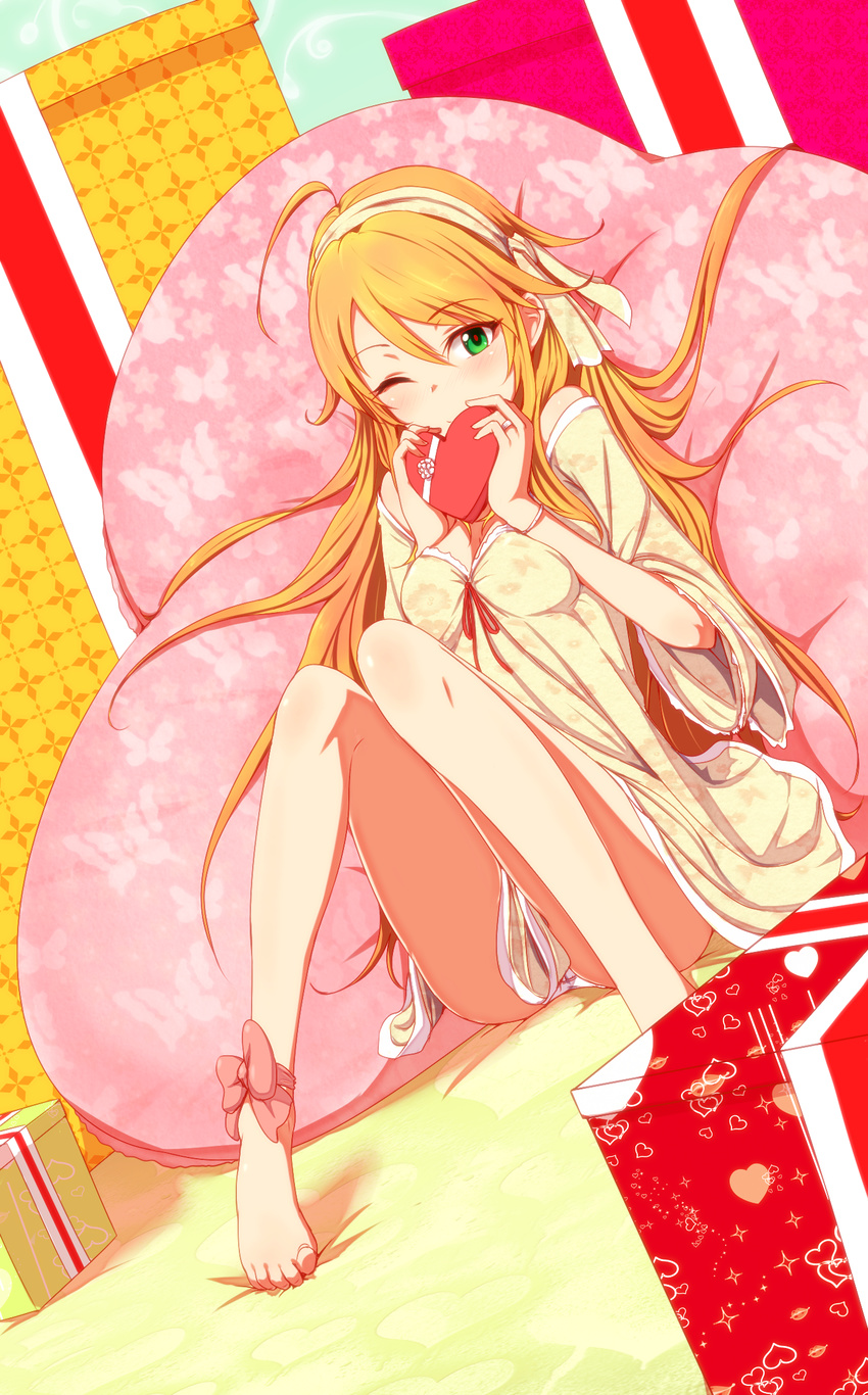 ahoge ankle_ribbon bare_legs barefoot blonde_hair chocolate dress feet gift green_eyes hairband heart highres hoshii_miki idolmaster idolmaster_(classic) legs long_hair looking_at_viewer one_eye_closed pillow ribbon shirihime smile solo toe-point valentine