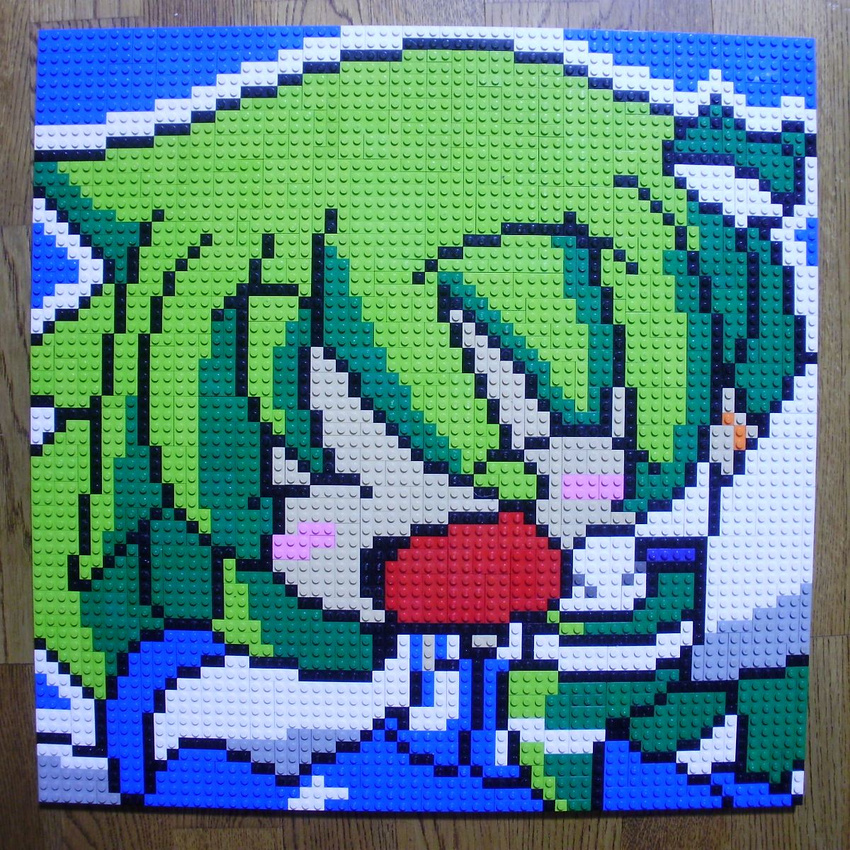 ^_^ arm_up blush_stickers closed_eyes derivative_work frog_hair_ornament green_hair hair_ornament highres kochiya_sanae lego open_mouth photo pixel_art smile solo table touhou upper_body you_rei_(blowback)