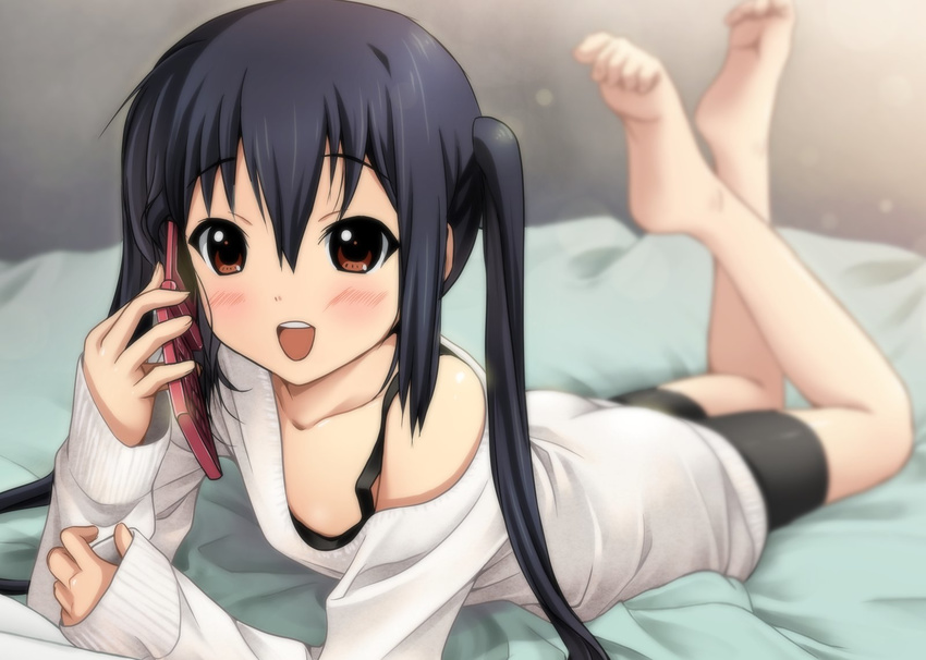 :d barefoot bike_shorts black_hair blurry blush brown_eyes cellphone depth_of_field dress highres k-on! legs_up long_hair looking_at_viewer lying nakano_azusa off_shoulder on_stomach open_mouth phone round_teeth ryunnu sleeves_past_wrists smile soles solo sweater sweater_dress teeth the_pose twintails