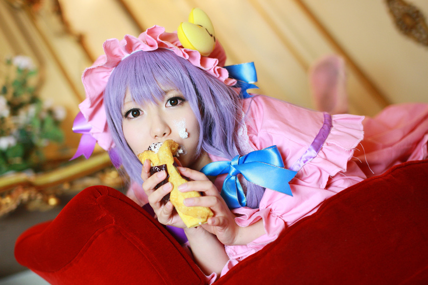 1girl asian cosplay couch cream crescent dessert dress female food hat long_hair patchouli_knowledge photo purple_hair solo tenshi_myu touhou